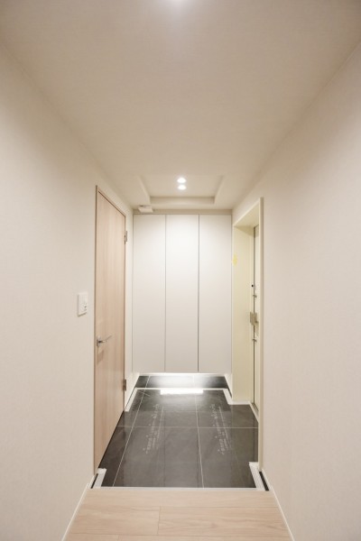 フットライトが明るく足元を照らす玄関です。人感センサーライトを設置しましたので、手が塞がっているときや遅い時間のご帰宅でも明るく家族を迎えてくれます。玄関収納も大容量です。