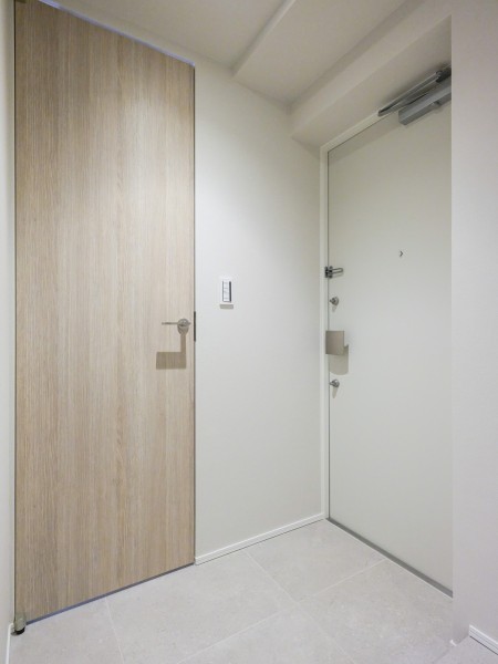 床に敷かれたタイルが落ち着いた雰囲気を醸す玄関ホールです。シューズインクローゼットがあり、ゆとりがある空間になりました。