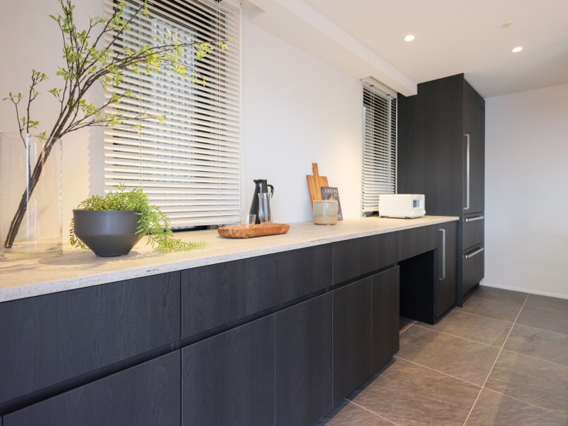 キッチンの背面には広さのあるカップボードを造作いたしました。モノトーンカラーで統一し、大人モダンの空間です。棚が複数あり、収納しやすい仕様です。